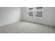 Bedroom with large window and neutral carpet at 216 Flag Lilly Ln, Umatilla, FL 32784