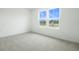 Bedroom with plush carpet, large windows offering scenic views at 216 Flag Lilly Ln, Umatilla, FL 32784
