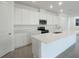 Bright, open kitchen with white cabinets, stainless steel appliances, and a large center island at 216 Flag Lilly Ln, Umatilla, FL 32784