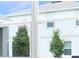 A view through a window showcases the home's exterior and surrounding landscaping at 216 Flag Lilly Ln, Umatilla, FL 32784