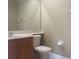 Modest bathroom featuring a vanity with sink, toilet, and a mirrored wall at 2255 Stone Lake Ct, Orlando, FL 32824