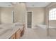 Spacious bathroom featuring double sinks, tile flooring, soaking tub and glass enclosed shower at 2255 Stone Lake Ct, Orlando, FL 32824
