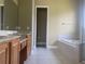 Bathroom featuring double sinks, a soaking tub, and a separate shower, creating a relaxing and functional space at 2255 Stone Lake Ct, Orlando, FL 32824