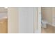 Bathroom area featuring a toilet and cabinet with a folding door at 2255 Stone Lake Ct, Orlando, FL 32824