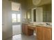 Bathroom with double vanities, neutral tile, and a separate shower, providing a luxurious and functional space at 2255 Stone Lake Ct, Orlando, FL 32824