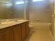 Bright bathroom features a double sink vanity, tiled flooring, and a shower-tub combo at 2255 Stone Lake Ct, Orlando, FL 32824