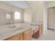 Bathroom featuring double sinks with wooden cabinets, tile flooring and a glass enclosed shower at 2255 Stone Lake Ct, Orlando, FL 32824