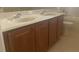 Bathroom boasts a double sink vanity with classic wood cabinetry and a tile floor at 2255 Stone Lake Ct, Orlando, FL 32824