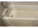 Close-up shot of a clean and well maintained bathtub with tile surround at 2255 Stone Lake Ct, Orlando, FL 32824