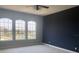 Bedroom featuring natural light from arched windows, complemented by neutral carpet, and a dark accent wall at 2255 Stone Lake Ct, Orlando, FL 32824