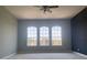 Bright bedroom featuring three large windows that fill the room with natural light and views of the surrounding neighborhood at 2255 Stone Lake Ct, Orlando, FL 32824