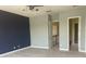 A bedroom boasts natural light from arched windows, plush neutral carpet, and a blue accent wall at 2255 Stone Lake Ct, Orlando, FL 32824