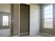 Carpeted bedroom showcasing a closet with sliding doors and a large window at 2255 Stone Lake Ct, Orlando, FL 32824