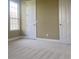 Empty bedroom featuring a large window and two doors at 2255 Stone Lake Ct, Orlando, FL 32824
