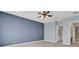 Bedroom with blue walls featuring a ceiling fan and access to a bathroom and closet at 2255 Stone Lake Ct, Orlando, FL 32824