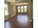 Dining room with hardwood floors, arched entryways and three big windows at 2255 Stone Lake Ct, Orlando, FL 32824
