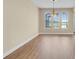 Elegant dining area with hardwood floors, pendant lighting, and views of the pond through arched windows at 2255 Stone Lake Ct, Orlando, FL 32824