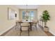 Formal dining room with large windows, a pendant light, and seating for six at the table at 2255 Stone Lake Ct, Orlando, FL 32824