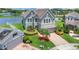Aerial view of a two-story home with lush landscaping, brick driveway, and large windows at 2255 Stone Lake Ct, Orlando, FL 32824
