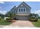 Charming two-story home with a brick driveway and well-maintained landscaping and a gray two-car garage at 2255 Stone Lake Ct, Orlando, FL 32824