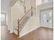 Welcoming foyer featuring a staircase, wood floors, and natural light from the front door at 2255 Stone Lake Ct, Orlando, FL 32824
