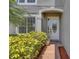 Inviting entrance with brick walkway, decorative bushes, and an elegant glass-accented front door at 2255 Stone Lake Ct, Orlando, FL 32824