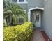 Beautiful white front door flanked by green bushes along a brick walkway at 2255 Stone Lake Ct, Orlando, FL 32824