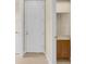 Hallway view with a laundry room and half bathroom on either side of a door at 2255 Stone Lake Ct, Orlando, FL 32824