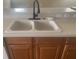 Kitchen features a double basin sink, a dark faucet, light countertops, and wood cabinetry at 2255 Stone Lake Ct, Orlando, FL 32824