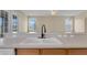 Close-up of a kitchen sink with a matte black faucet and views of the backyard at 2255 Stone Lake Ct, Orlando, FL 32824