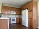 Efficient kitchen boasts plentiful wood cabinets, white appliances, and laminate flooring at 2255 Stone Lake Ct, Orlando, FL 32824