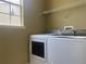 Laundry room features a white washer and dryer set by a bright window at 2255 Stone Lake Ct, Orlando, FL 32824
