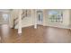 Spacious living room with hardwood floors, columns, and multiple windows for ample natural light at 2255 Stone Lake Ct, Orlando, FL 32824