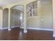Open living room with hardwood floors, arched entryways and view to the dining room at 2255 Stone Lake Ct, Orlando, FL 32824