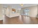 Open-concept living room with wood floors, doors to the patio and kitchen at 2255 Stone Lake Ct, Orlando, FL 32824