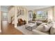 Bright living room with hardwood floors, a cozy sectional sofa, and stairs to the second level at 2255 Stone Lake Ct, Orlando, FL 32824