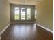 Inviting living room with beautiful flooring, large windows showcasing scenic outdoor views, and modern lighting at 2255 Stone Lake Ct, Orlando, FL 32824