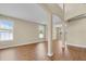 Open-concept living space with columns, hard wood floors, and plenty of natural light at 2255 Stone Lake Ct, Orlando, FL 32824