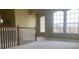 Loft area illuminated by arched windows, offering a bright and airy space with neutral carpet and paint at 2255 Stone Lake Ct, Orlando, FL 32824