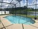 Inviting screened-in pool area with a view of the lake and landscaping beyond at 2255 Stone Lake Ct, Orlando, FL 32824