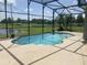 Inviting screened-in pool area with a view of the lake beyond the backyard at 2255 Stone Lake Ct, Orlando, FL 32824