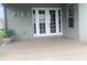 Covered porch with neutral flooring, decorative wall lanterns and french doors at 2255 Stone Lake Ct, Orlando, FL 32824