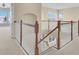 Bright staircase landing featuring wood and white railings and lots of natural light from arched windows at 2255 Stone Lake Ct, Orlando, FL 32824