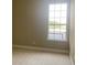 This sun-filled bedroom features neutral paint and a large window at 2255 Stone Lake Ct, Orlando, FL 32824