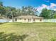 Spacious backyard featuring a lush lawn, white fencing, and a charming patio area for outdoor enjoyment at 2493 Pine Chase Cir, St Cloud, FL 34769