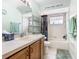 This bathroom features a bathtub, toilet, a sink, and a vanity with wooden cabinets at 2493 Pine Chase Cir, St Cloud, FL 34769