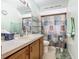 The bathroom features a mirror, cabinets, a toilet, and a decorative shower curtain at 2493 Pine Chase Cir, St Cloud, FL 34769