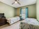 Bright bedroom features two beds and an olive green painted wall at 2493 Pine Chase Cir, St Cloud, FL 34769