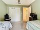 This bedroom features carpet, a closet, two twin beds, and calming green walls at 2493 Pine Chase Cir, St Cloud, FL 34769