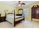 Bedroom with ceiling fan, dark wooden furniture, and Peter Pan themed wall art at 2493 Pine Chase Cir, St Cloud, FL 34769